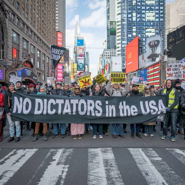 Protesters hold a banner reading "No Dictators in the USA" during a No Kings protest