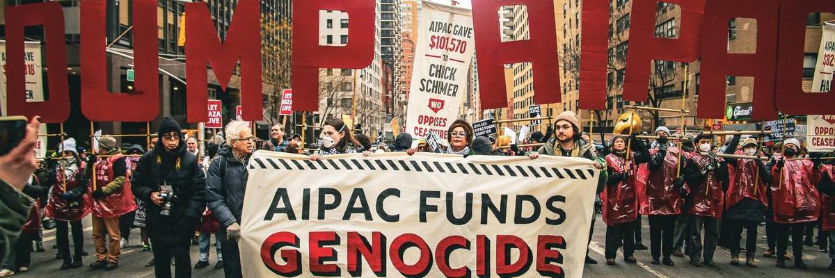 protesters hold a sign reading "AIPAC Funds Genocide" during a protest march
