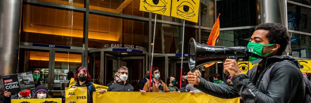 Protesters hold a sign reading "All Eyes on BlackRock" outside the wealth management firm's headquarters.