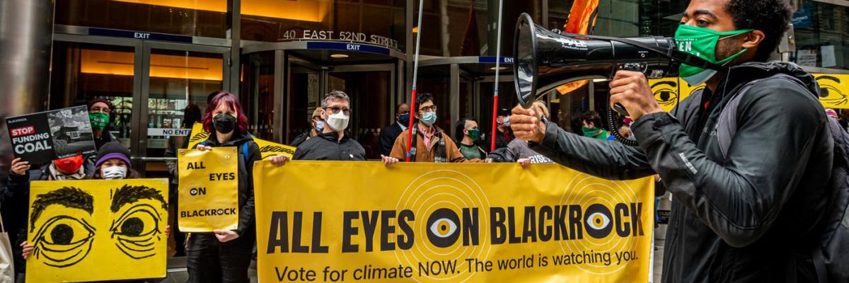 Protesters hold a sign reading "All Eyes on BlackRock" outside the wealth management firm's headquarters.