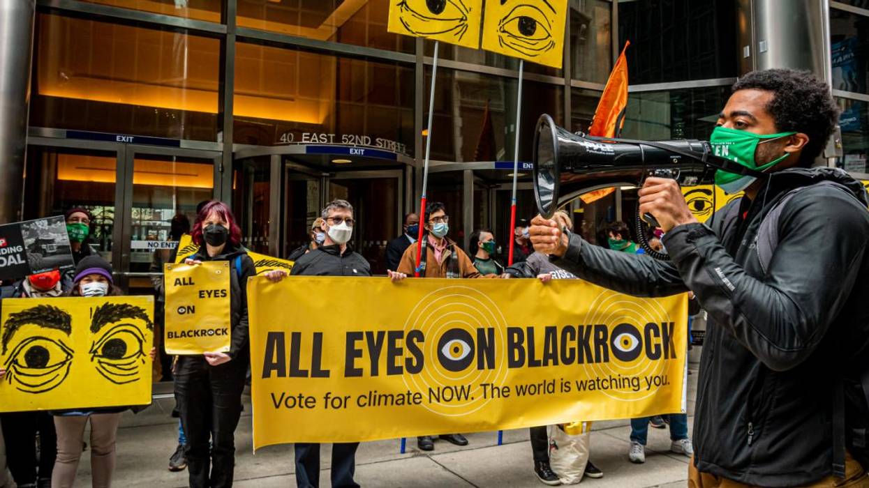 Protesters hold a sign reading "All Eyes on BlackRock" outside the wealth management firm's headquarters.