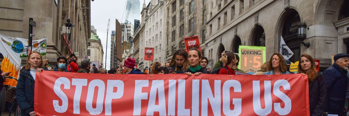 Protesters hold a "Stop Failing Us'' banner during the demonstration outside the Bank of England in London as world leaders meet in Glasgow for the COP26 climate summit on November 6, 2021. 