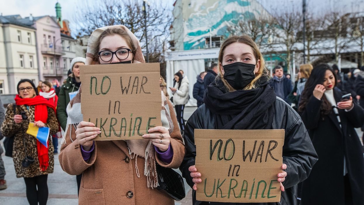 Protesters hold anti-war signs and Ukrainian flags in Sopot, Poland on February 26, 2022.