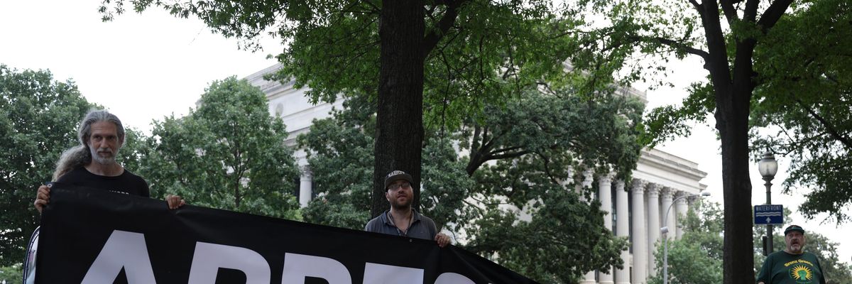 Protesters hold "Arrest Trump" sign in DC