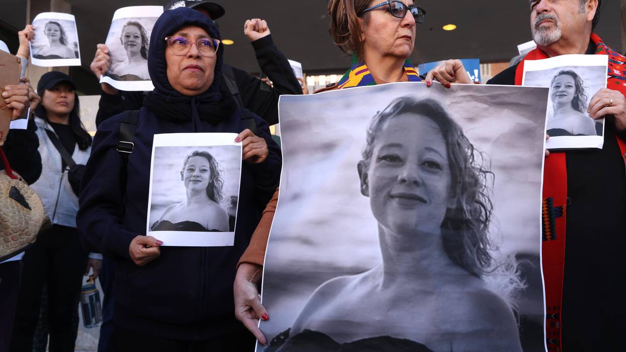 Protesters hold photos of Renee Good