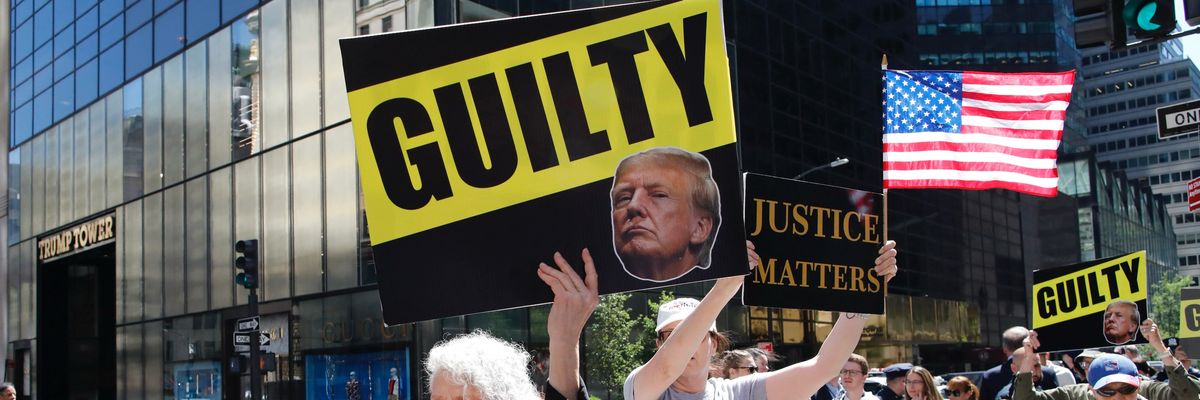 Protesters hold placards outside Trump Tower in New York City