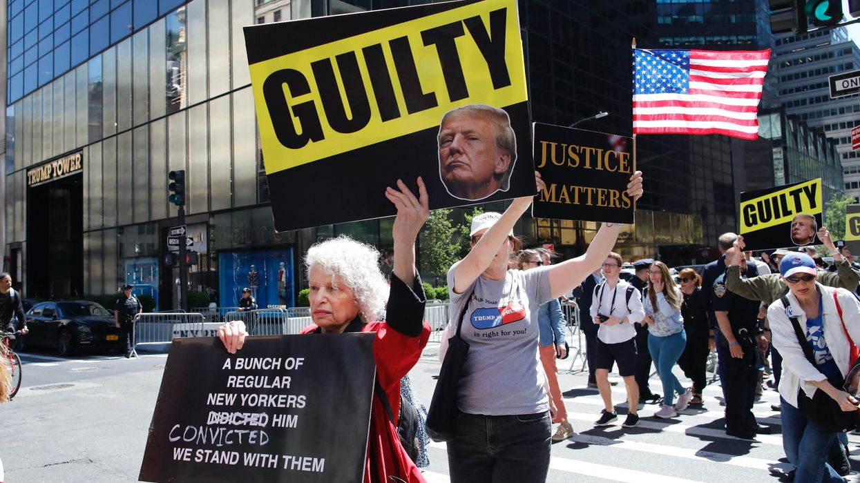 Protesters hold placards outside Trump Tower in New York City