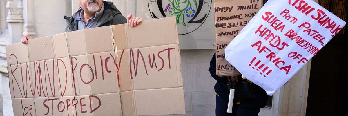 Protesters hold placards