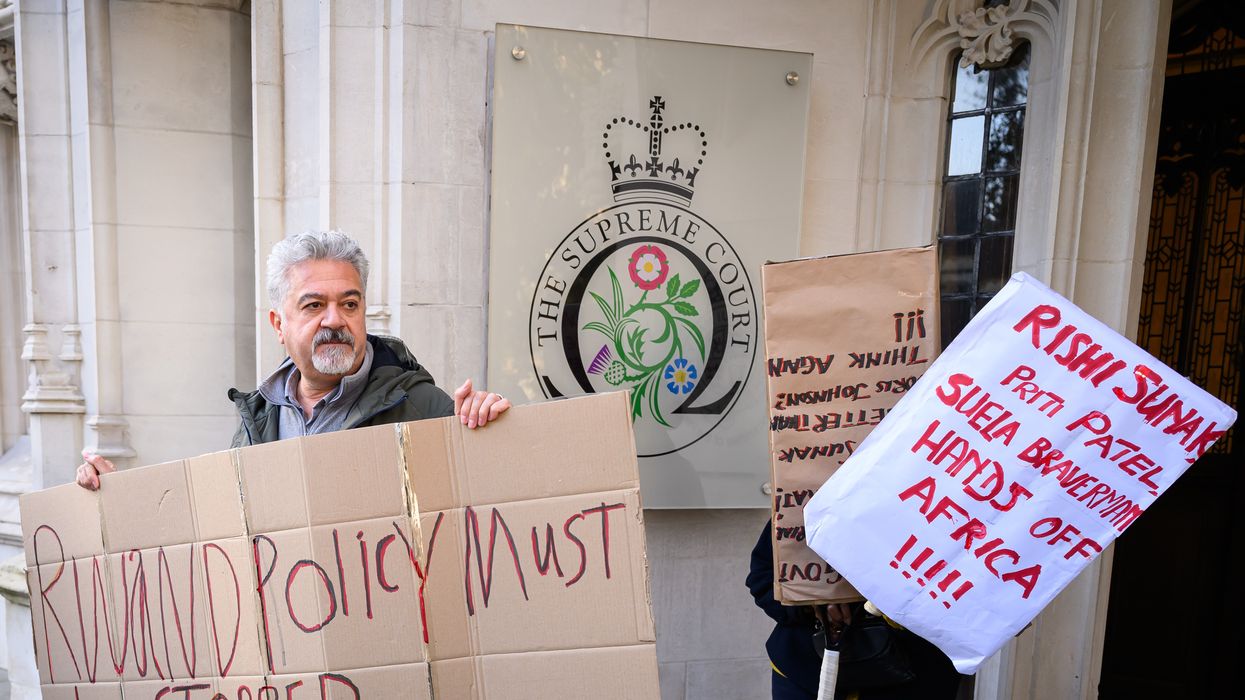 Protesters hold placards