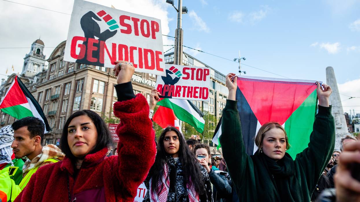 Protesters hold signs denouncing genocide