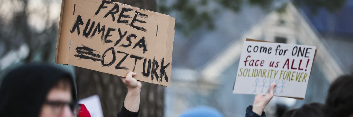 Protesters hold signs reading, "Free Rumeysa Ozturk"