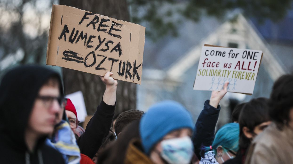 Protesters hold signs reading, "Free Rumeysa Ozturk"