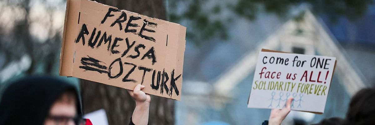 Protesters hold signs reading "Free Rumeysa Ozturk"