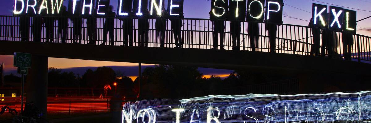 Protesters hold Stop KXL signs