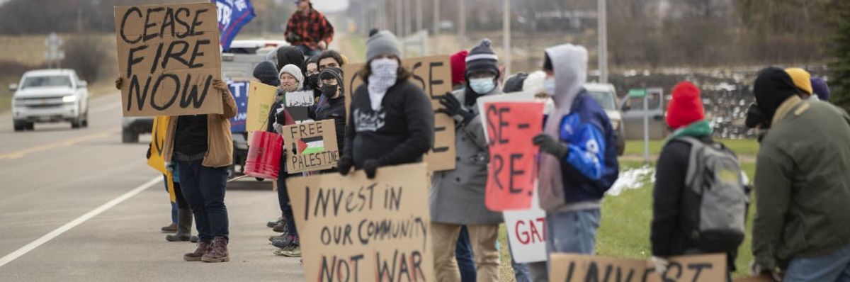 Protesters holding Palestinian flags and banners demand a ceasefire on the Israeli-Palestinian conflict outside of Dutch Creek Farms