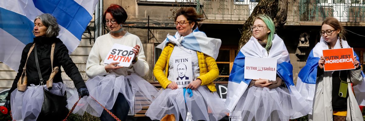 Protesters in ballerina skirts protest the Russian election.