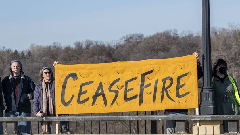Protesters in Minnesota hold up a banner reading "Cease-fire."