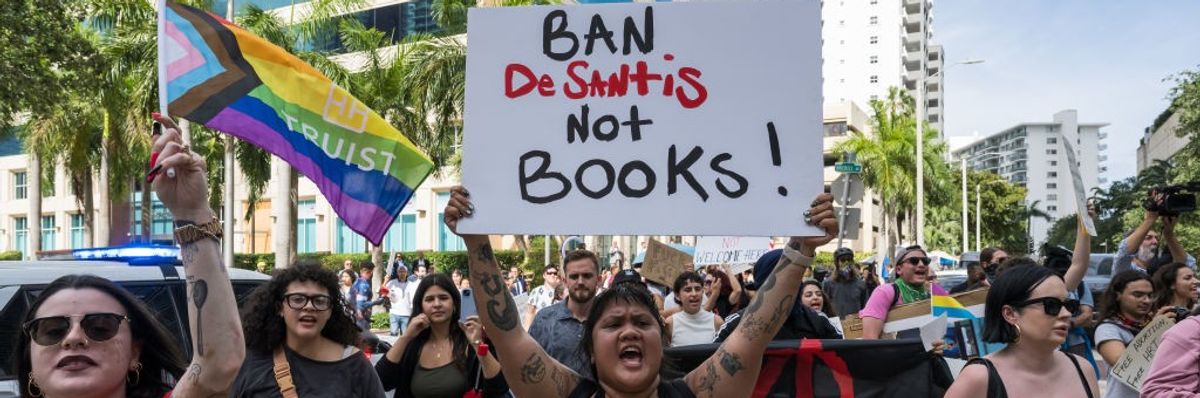 Protesters march while the Democratic National Committee's Mobile Billboard drives through the streets of Miami ahead of Governor Ron DeSantis' Presidential campaign launch on May 24, 2023 in Miami, Florida.