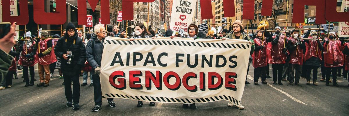 Protesters march with a banner reading, "AIPAC funds genocide."