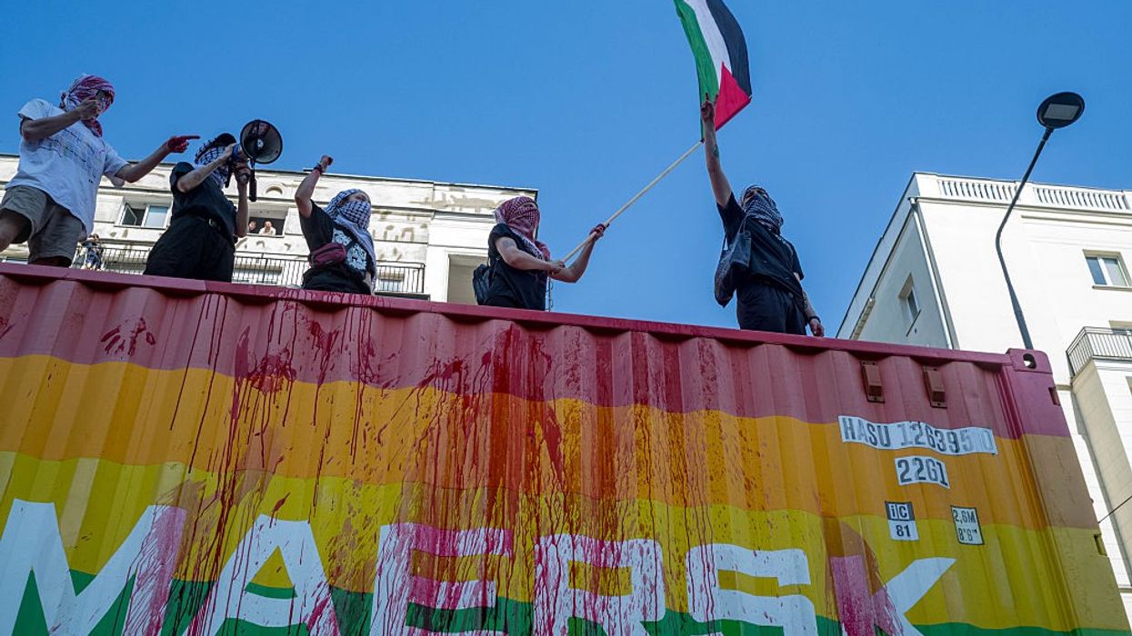 Protesters on top of the Maersk vehicle chant anti-genocide...