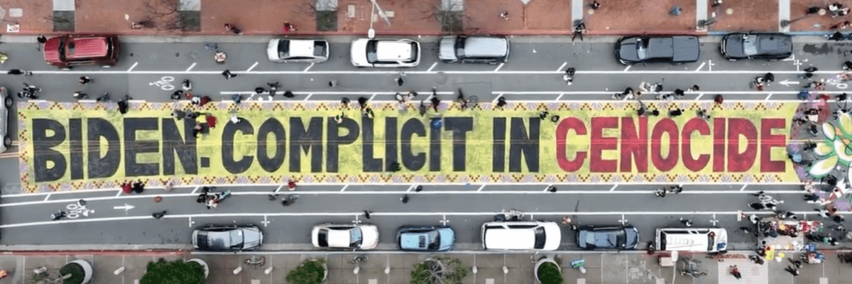 Protesters painted the message, "Biden complicit in genocide," on a city street