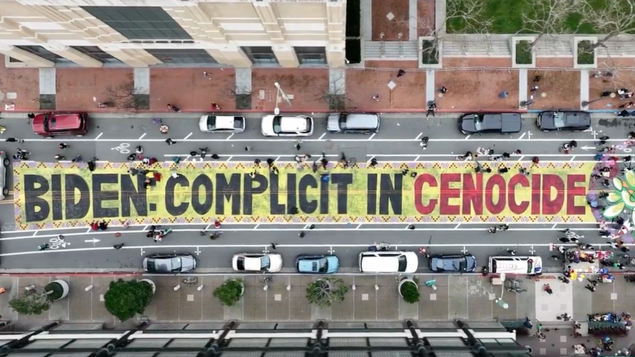 Protesters painted the message, "Biden complicit in genocide," on a city street