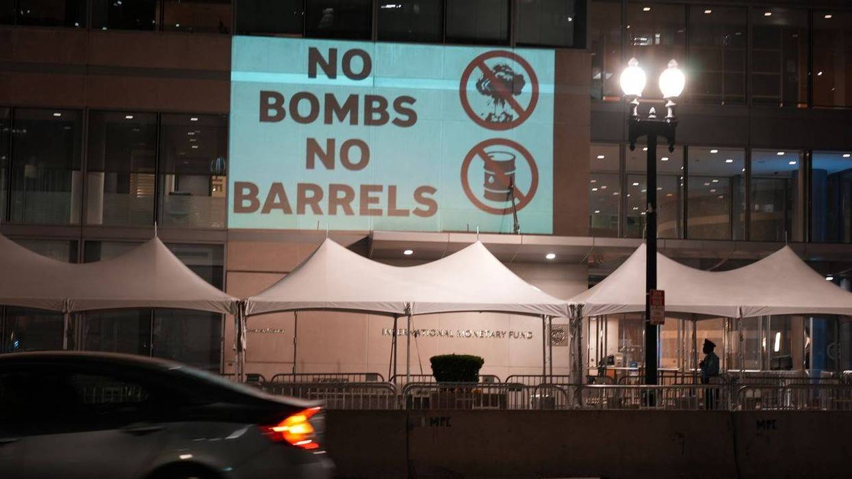 Protesters projected "No Bombs, No Barrels"