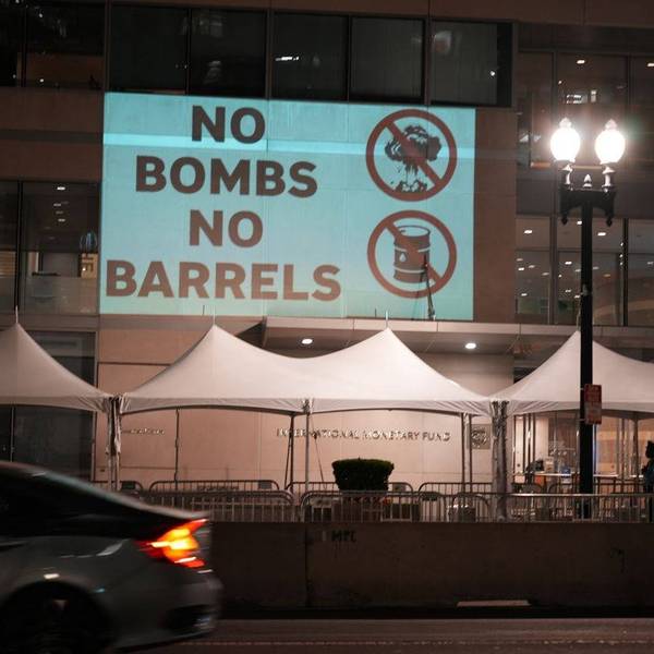 Protesters projected "No Bombs, No Barrels"