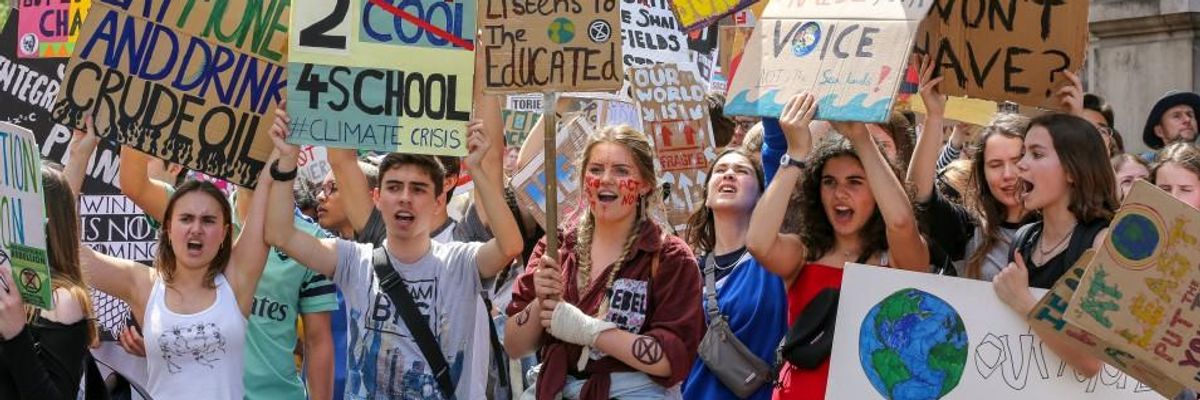 protesters raise signs