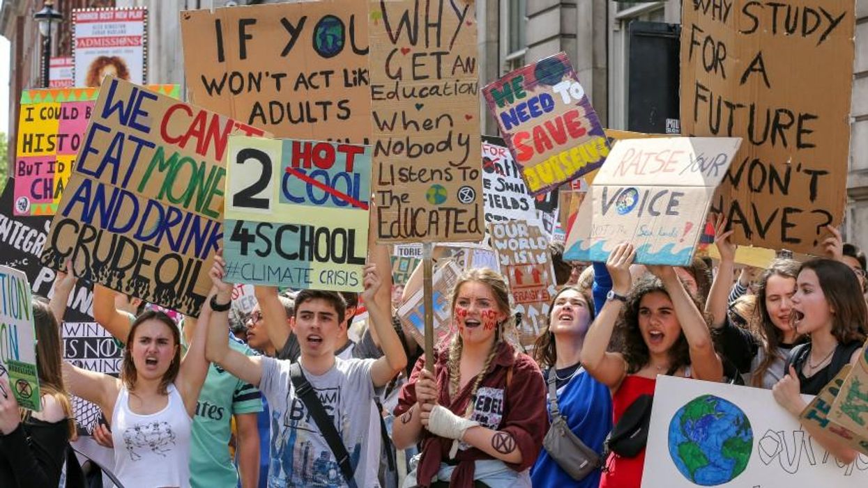 protesters raise signs