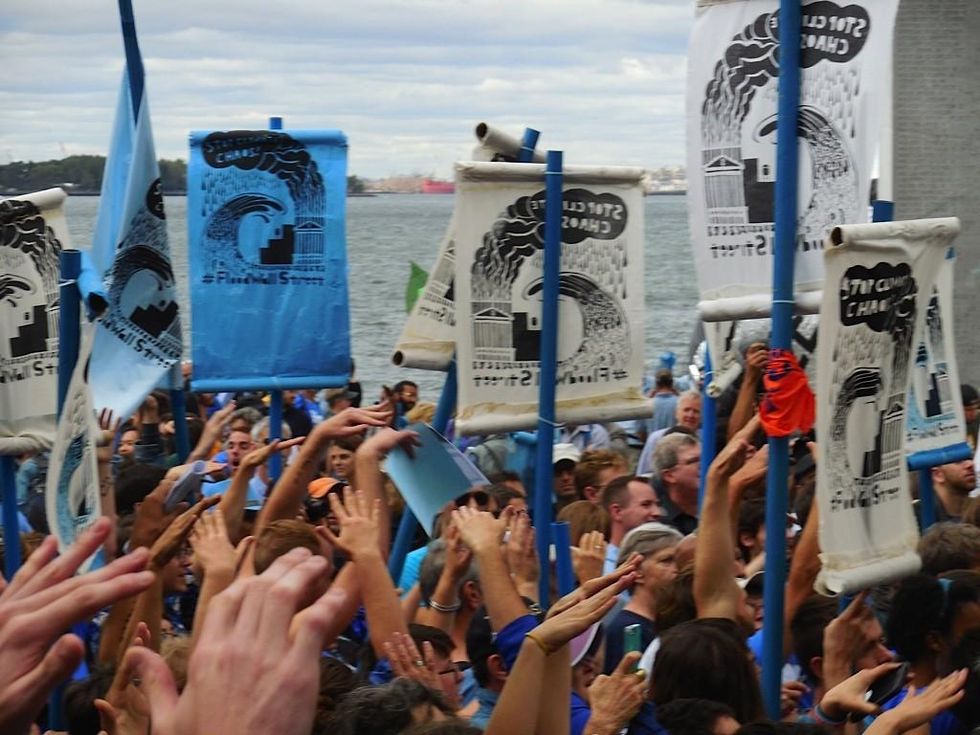Protesters raise their hands during a rally before Flood Wall Street on September 22, 2014.(Photo: Meaghan LaSala/Creative Commons)