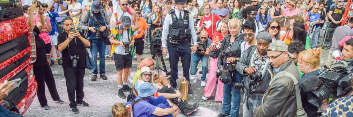 Protesters sit and block the road during the London Pride parade.