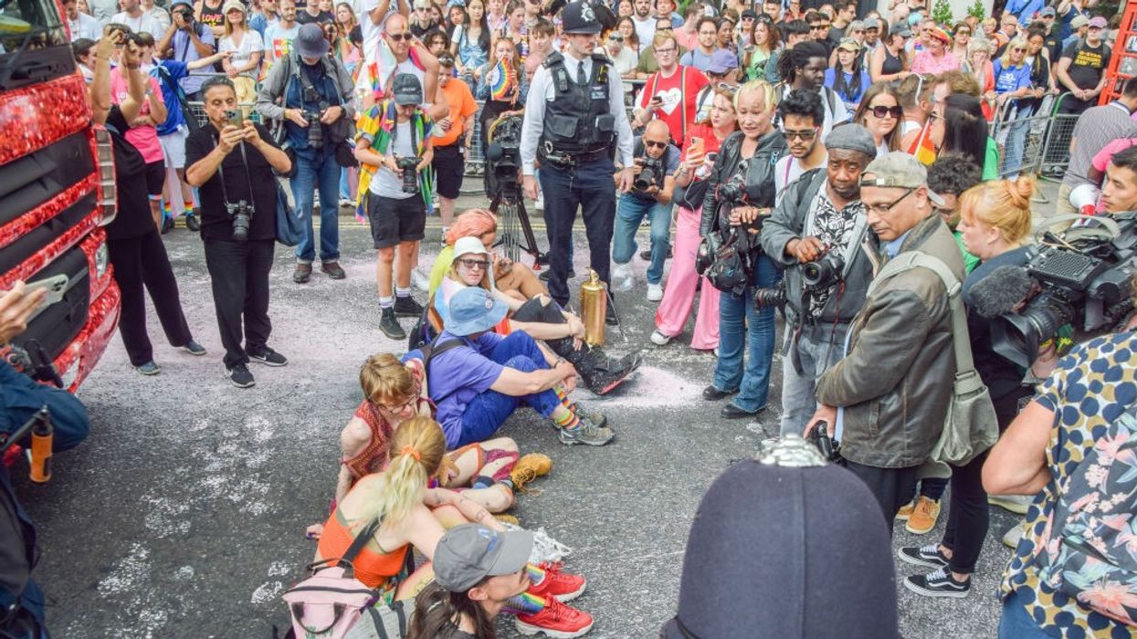 Protesters sit and block the road during the London Pride parade.