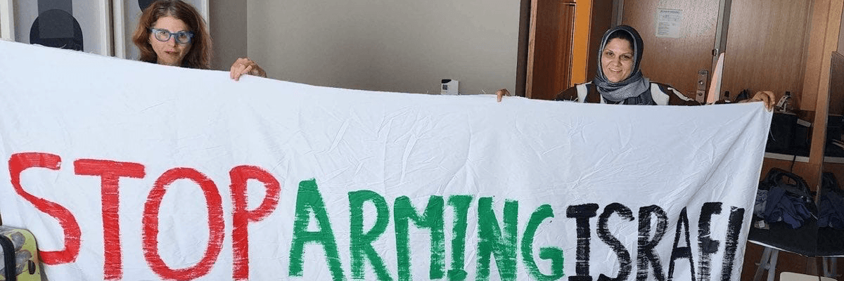 Protesters unfurl banner at DNC.