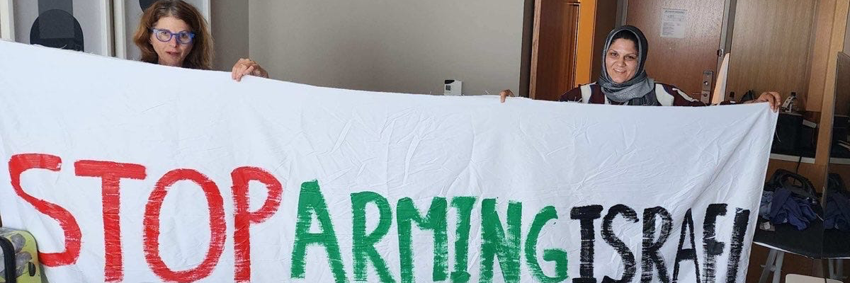 Protesters unfurl banner at DNC.