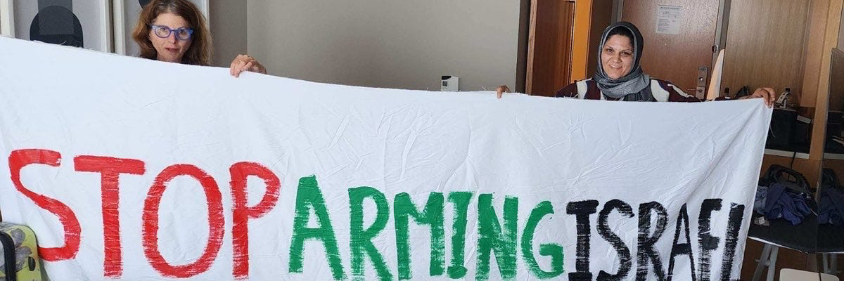 Protesters unfurl banner at DNC.