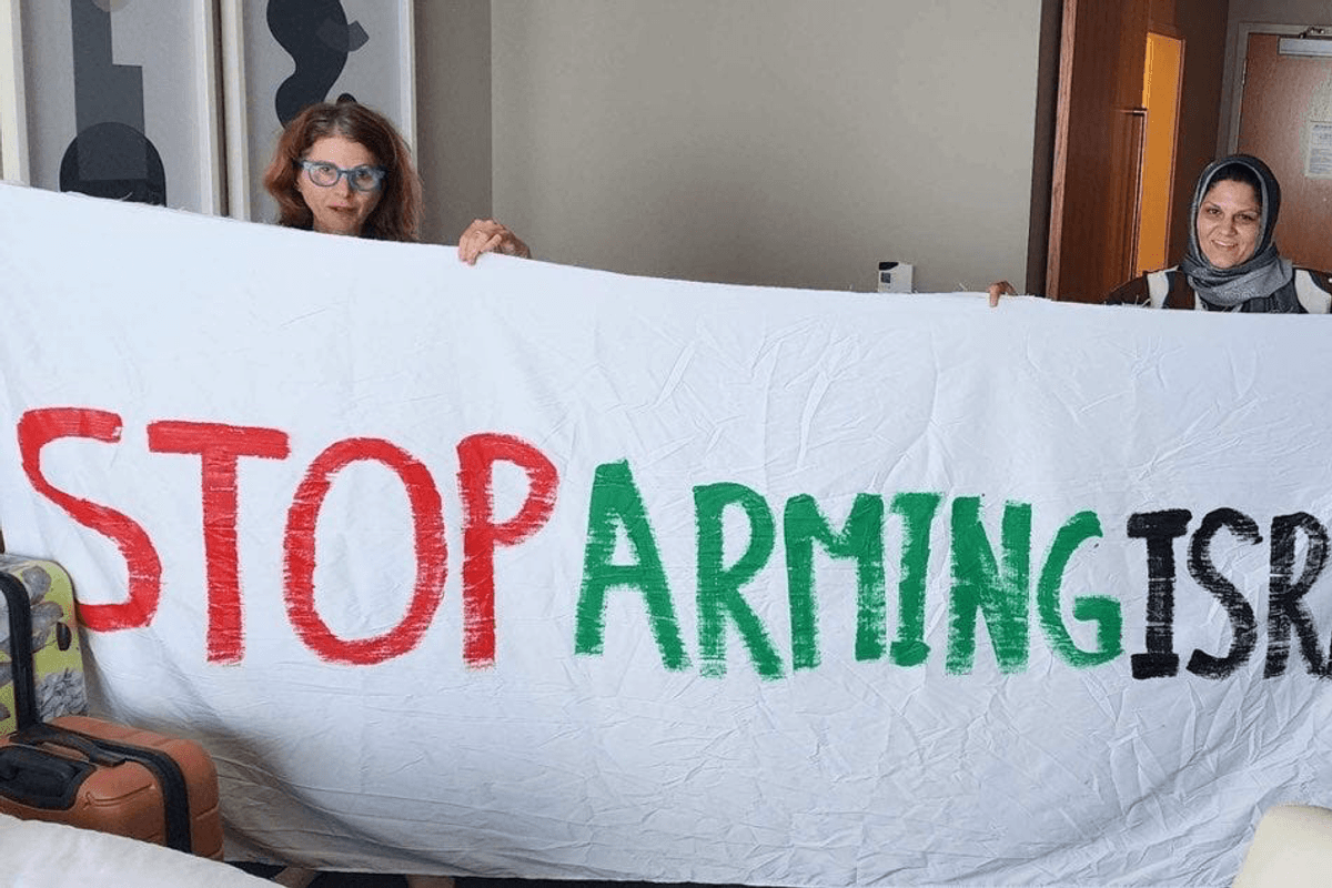Protesters unfurl banner at DNC.