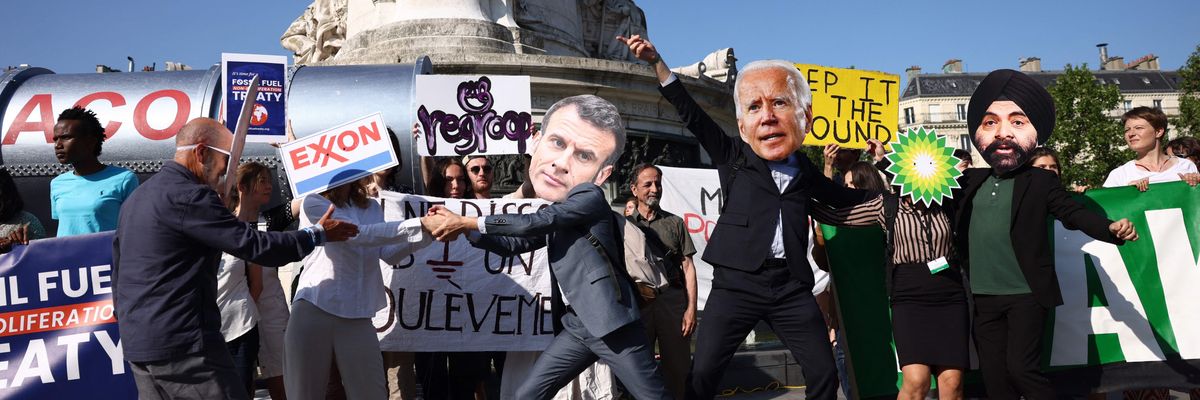 Protesters wearing masks in the likeness of French President Emmanuel Macron, U.S. President Joe Biden, and World Bank President Ajay Banga demonstrate against fossil fuels
