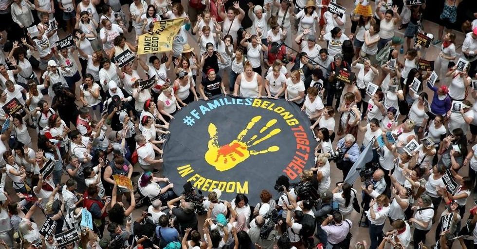 Protesters who marched from Freedom Plaza to the U.S. Capitol demonstrate inside the Hart Senate Office Building against family detentions and to demand the end of criminalizing efforts of asylum seekers and immigrants on June 28, 2018 in Washington, D.C. (Photo: Win McNamee/Getty Images)