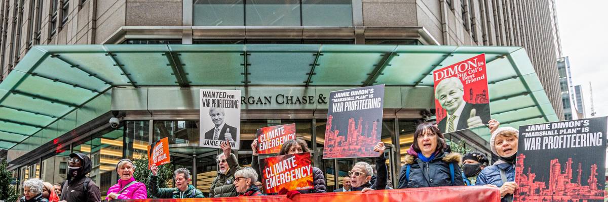 Protesters with banner reading, "Chase funds climate crimes"
