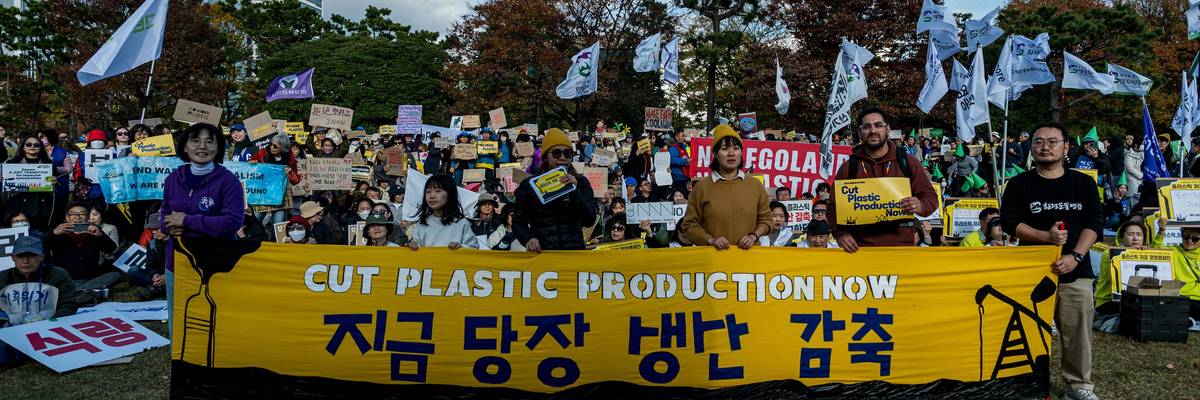 Protesters with banner that reads, "Cut Plastic Production Now"