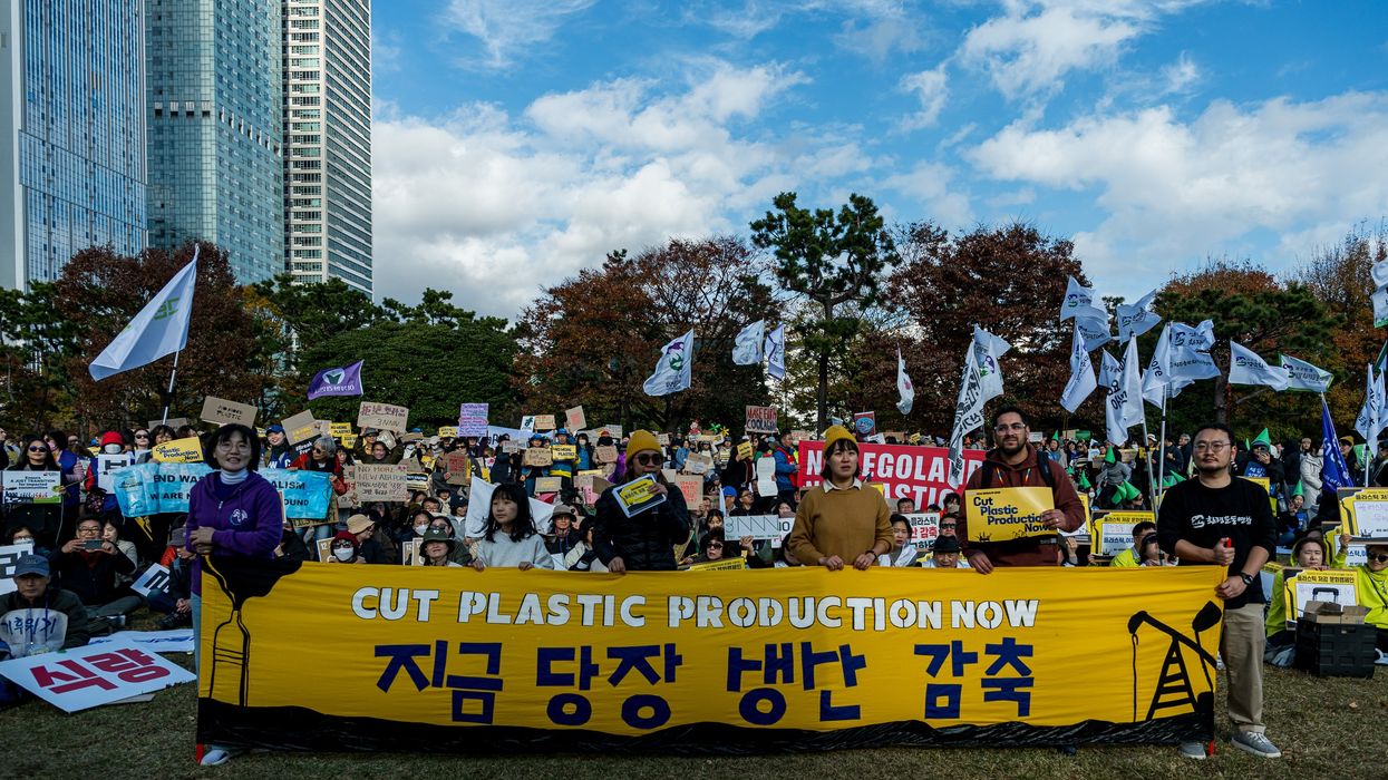 Protesters with banner that reads, "Cut Plastic Production Now"
