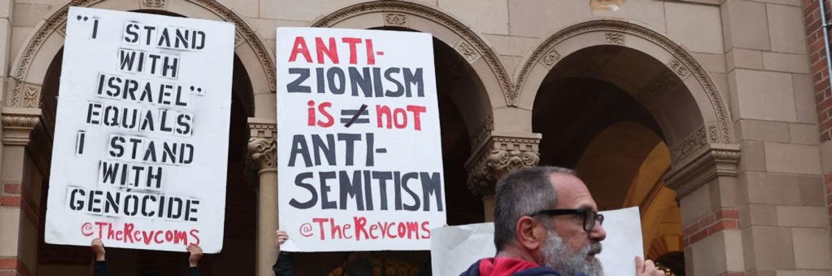 Protesters with signs including one reading "anti-Zionism does not equal antisemitism."