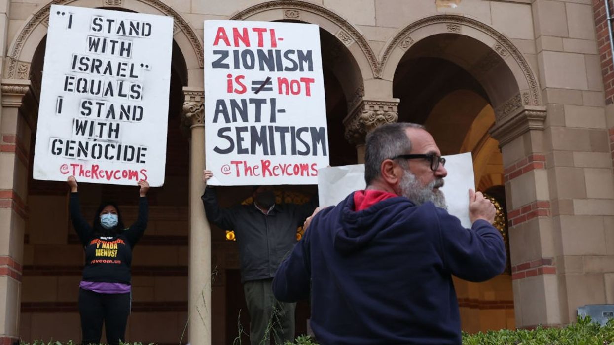 Protesters with signs including one reading "anti-Zionism does not equal antisemitism."