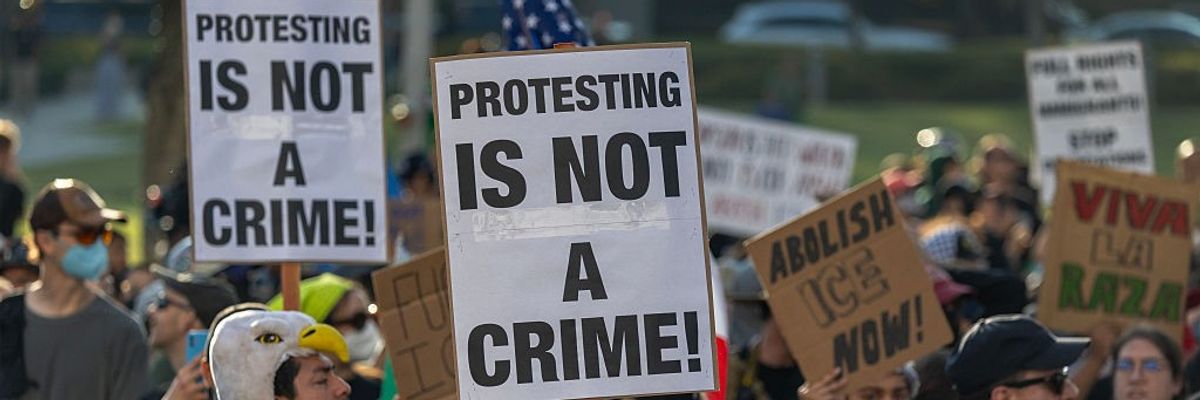 "Protesting Is Not a Crime," signs say