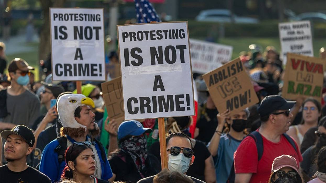 "Protesting Is Not a Crime," signs say