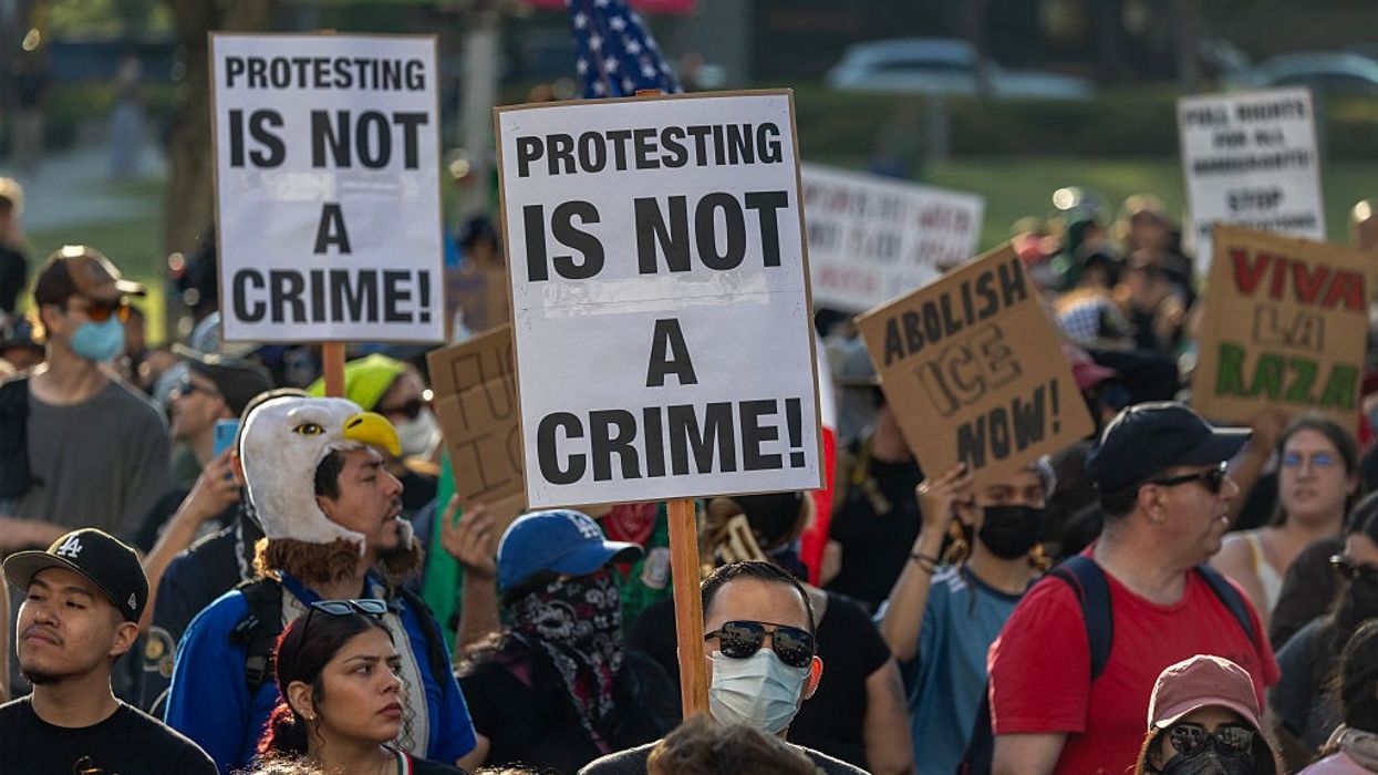 "Protesting Is Not a Crime," signs say
