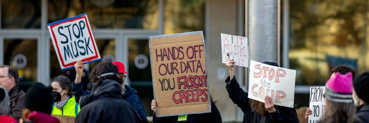 Protestors gather outside of the United States Office of...