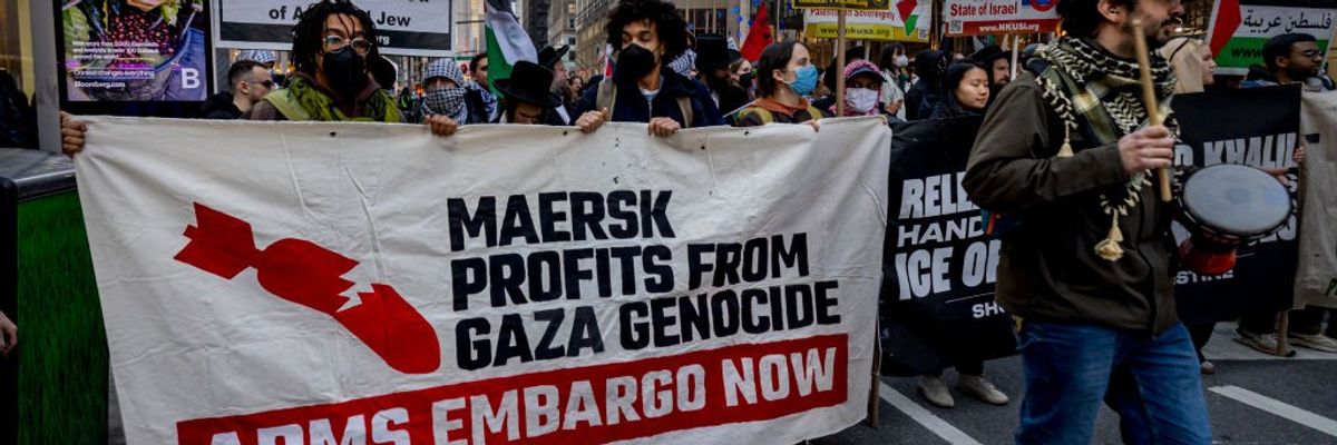 Protestors hold a banner that reads: "Maersk profits from Gaza genocide."
