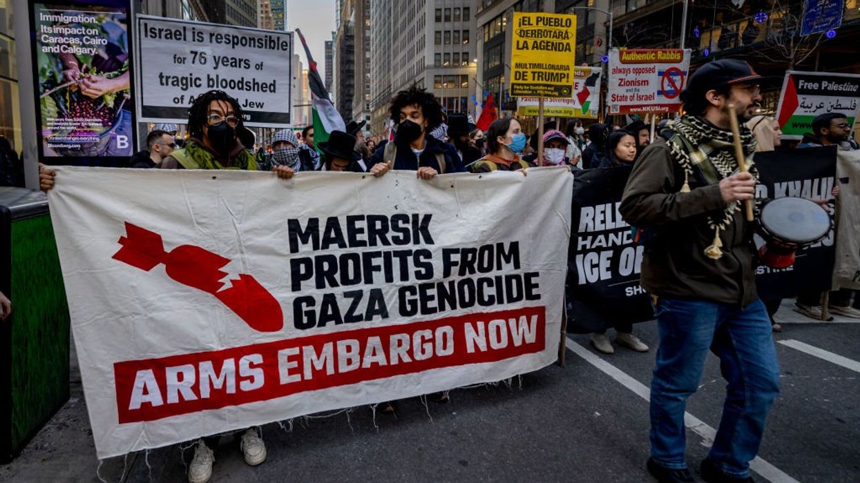 Protestors hold a banner that reads: "Maersk profits from Gaza genocide."